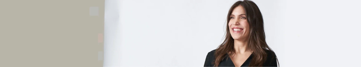 Smiling flight attendant in British Airways uniform against a neutral background.