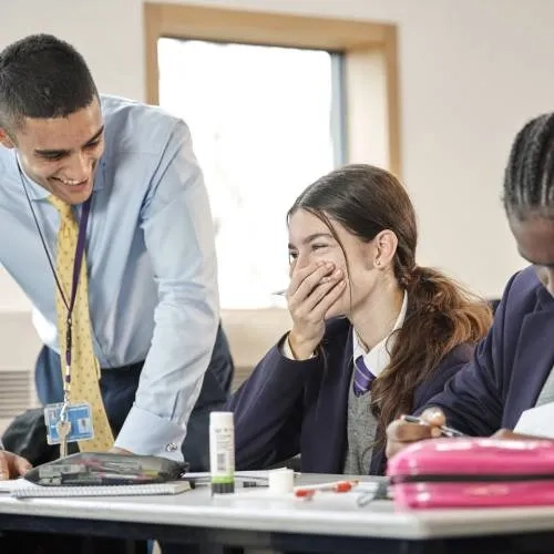 girl laughing with teacher